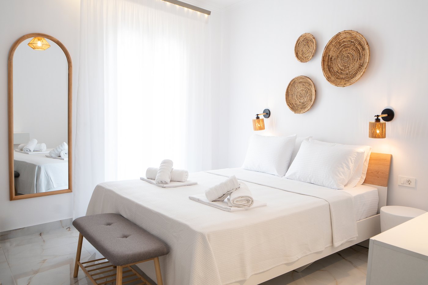 Tourkopazaro Aster bedroom with bright white linens and warm natural textures